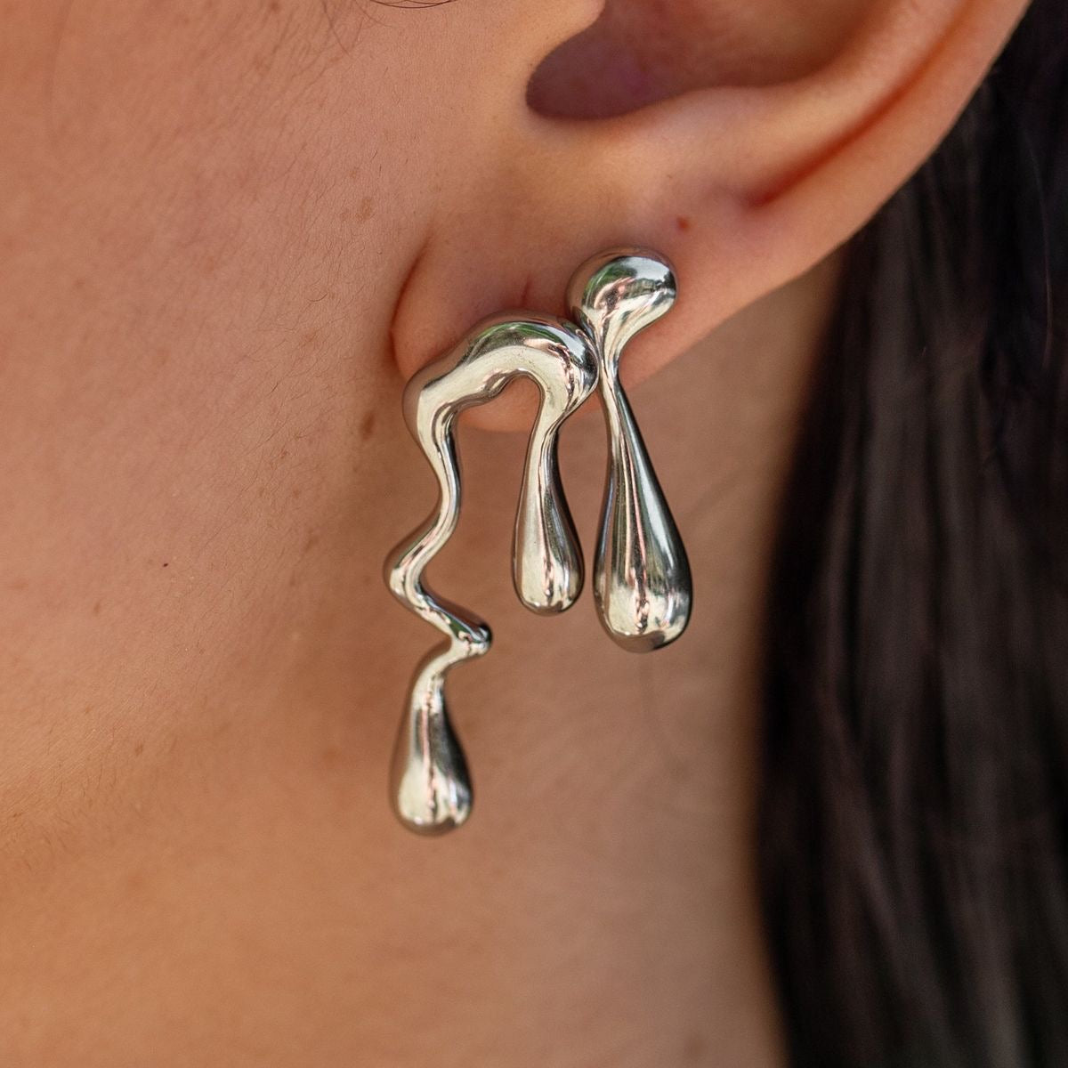 Irregular silver drop earrings.